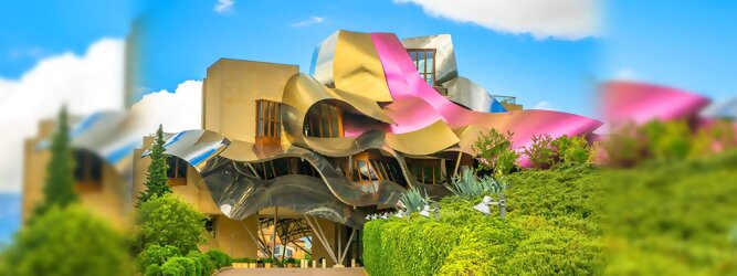 Trip Lettland Reisetipps - Marqués de Riscal Design Hotel, Bilbao, Elciego, Spanien. Fantastisch galaktisch, unverkennbar ein Werk von Frank O. Gehry. Inmitten idyllischer Weinberge in der Rioja Region des Baskenlandes, bezaubert das schimmernde Bauobjekt mit einer Struktur bunter, edel glänzender verflochtener Metallbänder. Glanz im Baskenland - Es muss etwas ganz Besonderes sein. Emotional, zukunftsweisend, einzigartig. Denn in dieser Region, etwa 133 km südlich von Bilbao, sind Weingüter normalerweise nicht für die Öffentlichkeit zugänglich.